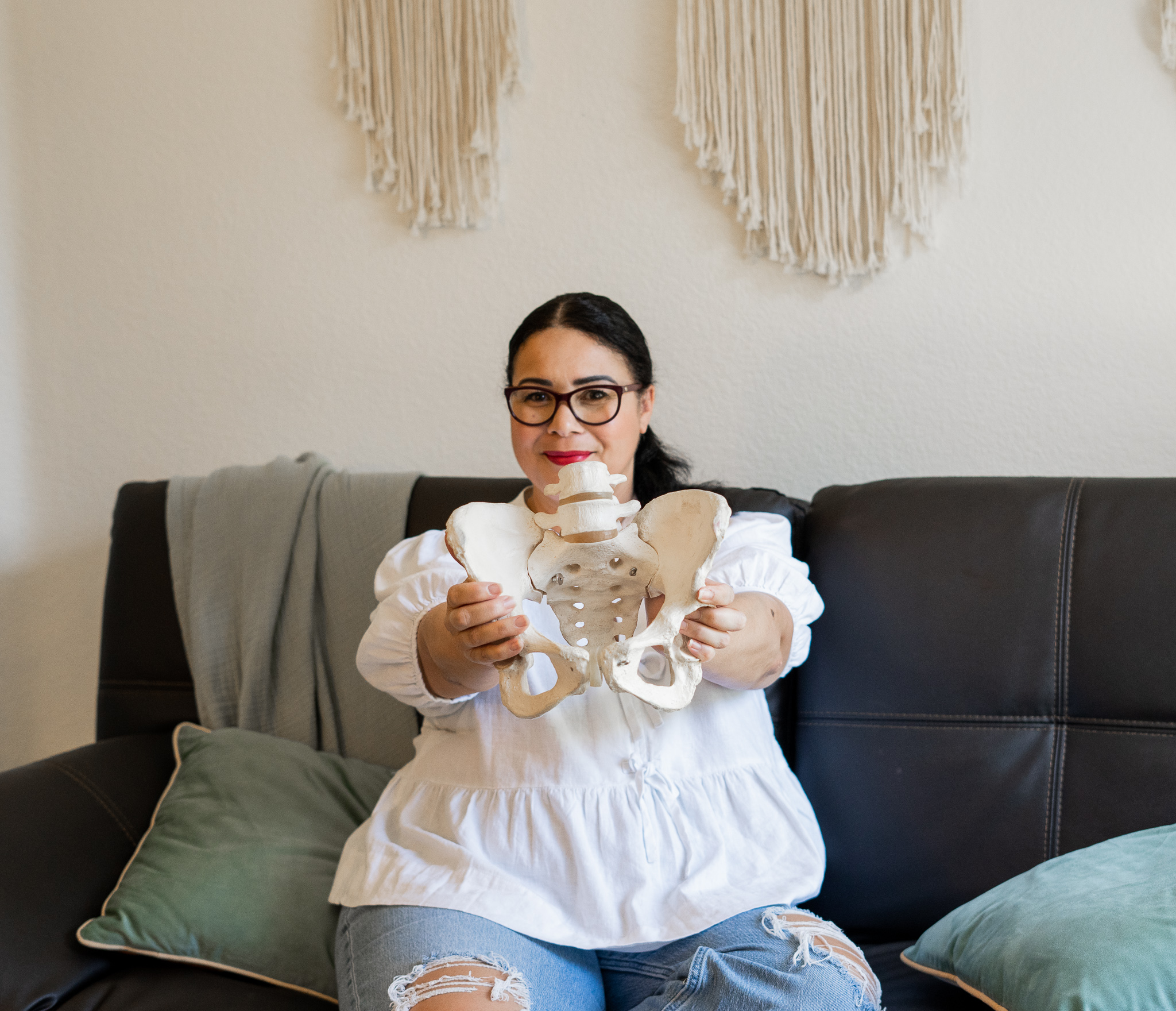 Tayna Chessman demonstrating a pelvic model during birth education