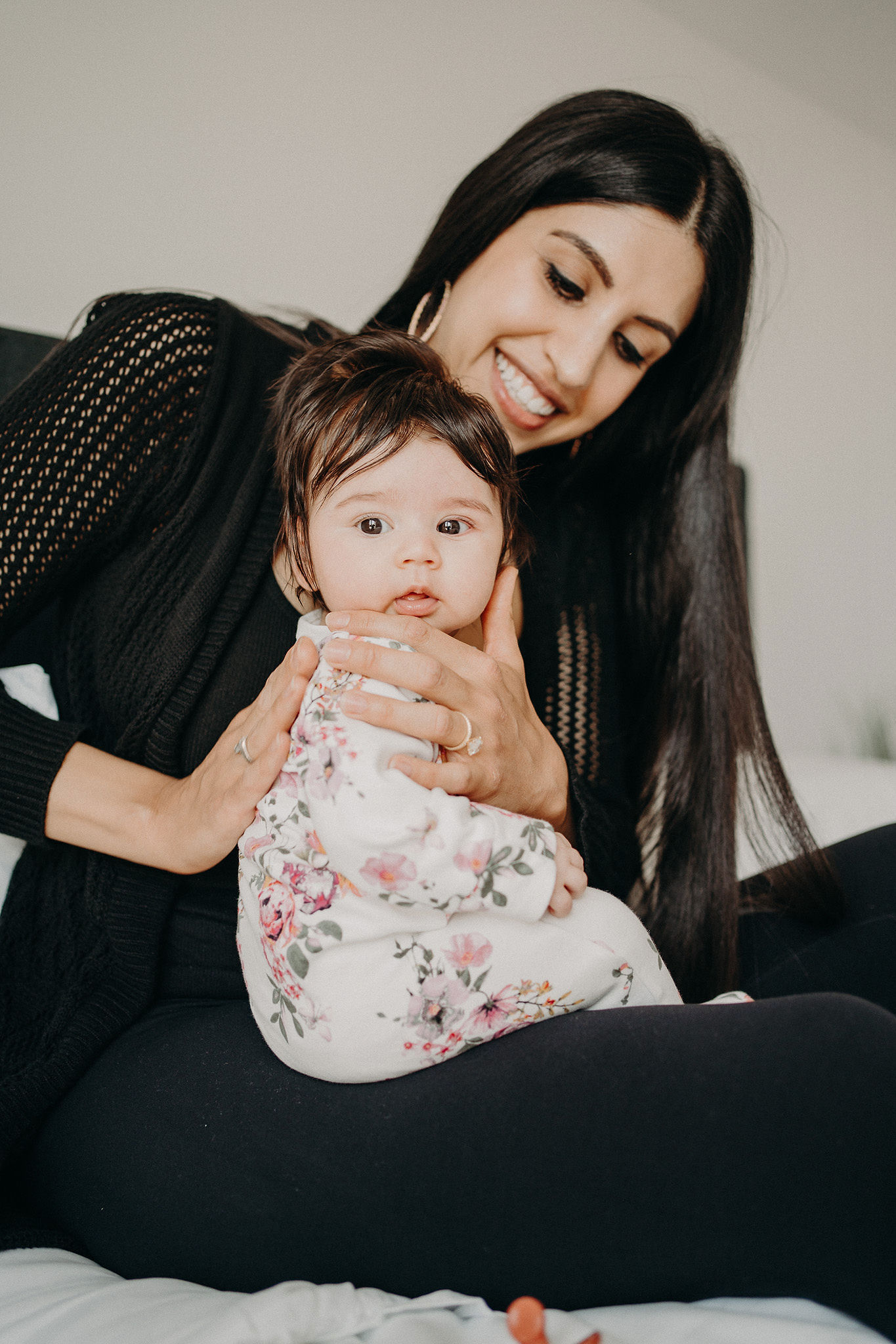 Mother smiling while holding her baby
