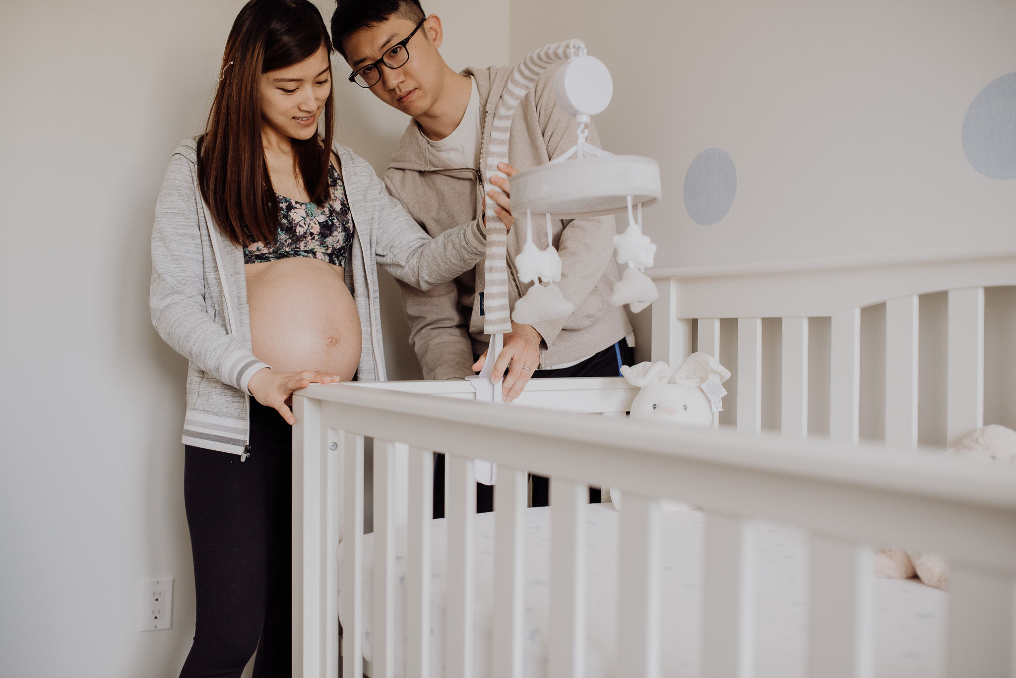 Expectant parents preparing their baby's nursery together